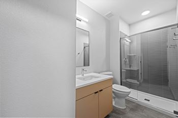 A bathroom with a toilet, sink, and shower.